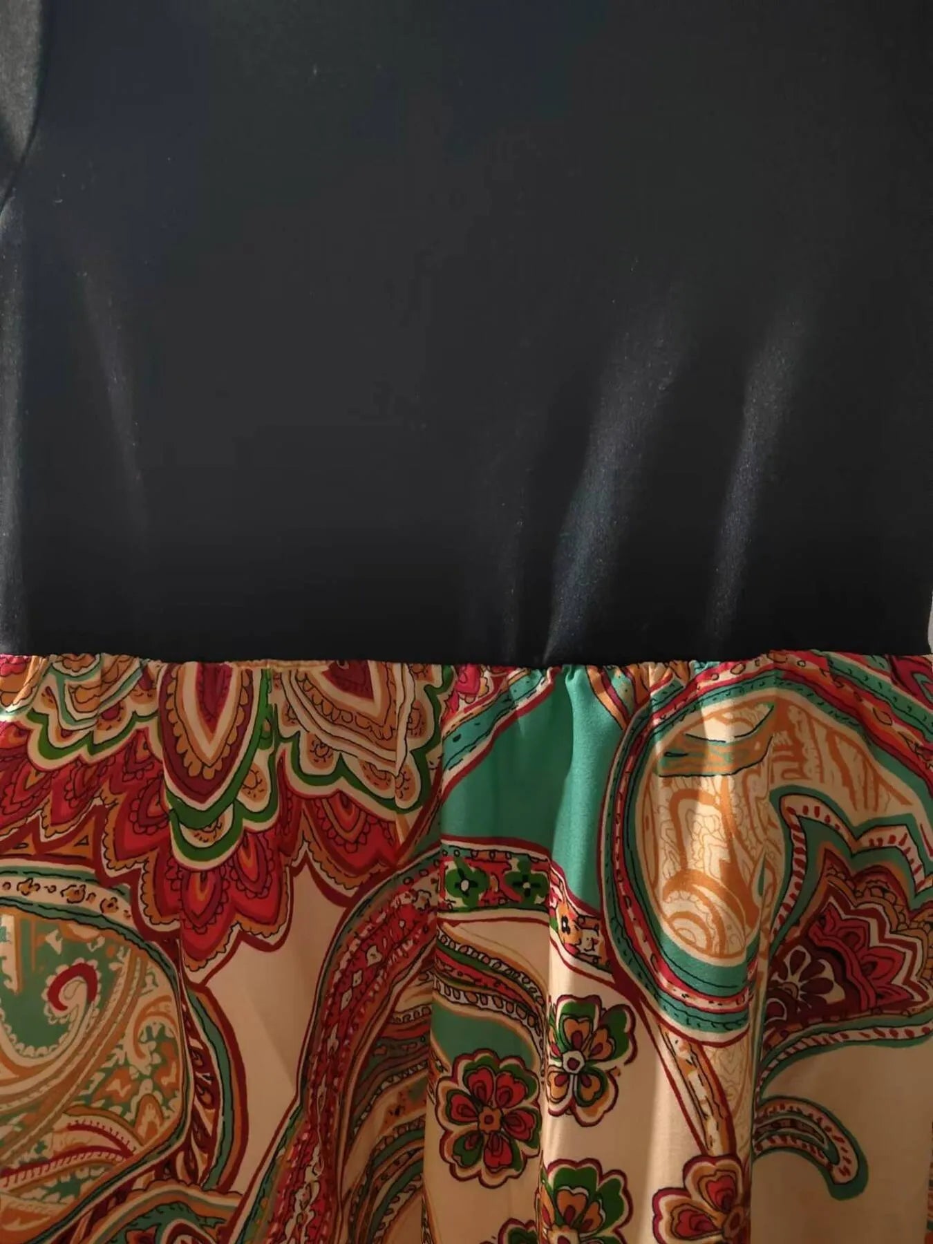 Children's printed short sleeve dress, featuring a colorful paisley skirt and black bodice for stylish play.
