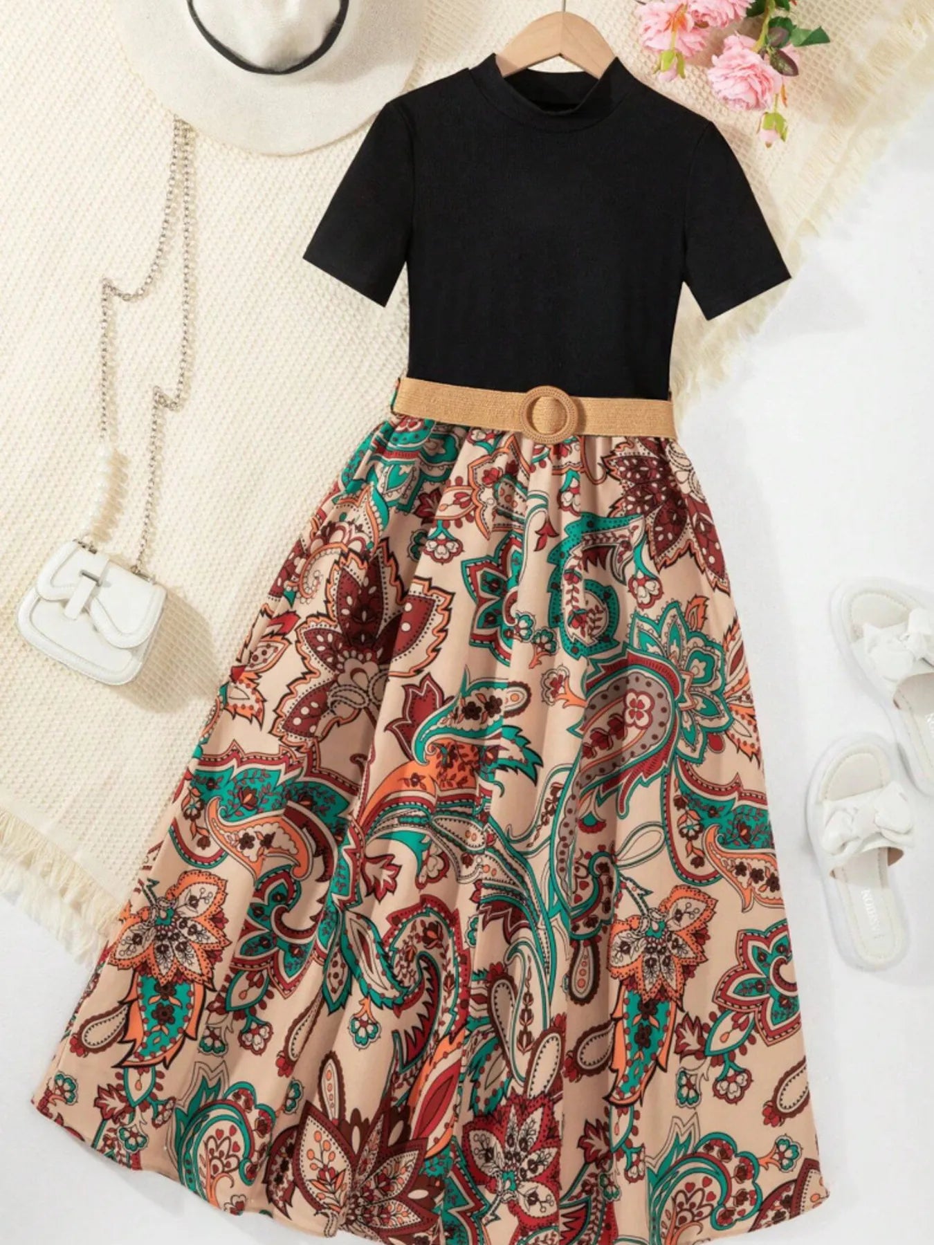 Children's black short sleeve dress with colorful paisley skirt and belt, perfect for casual outings.