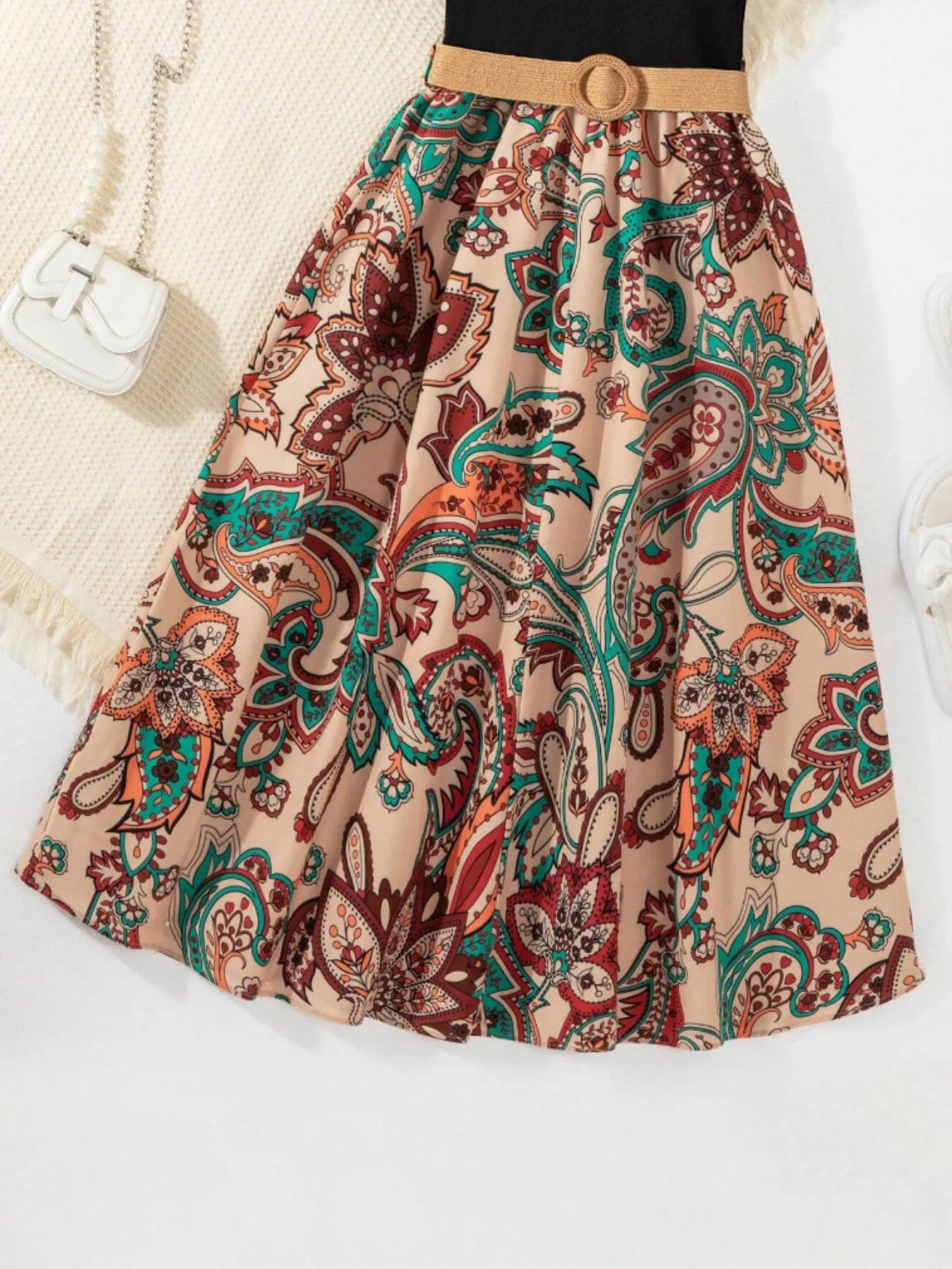 Children's printed skirt featuring colorful paisley patterns, designed with a belted waist, perfect for casual wear.